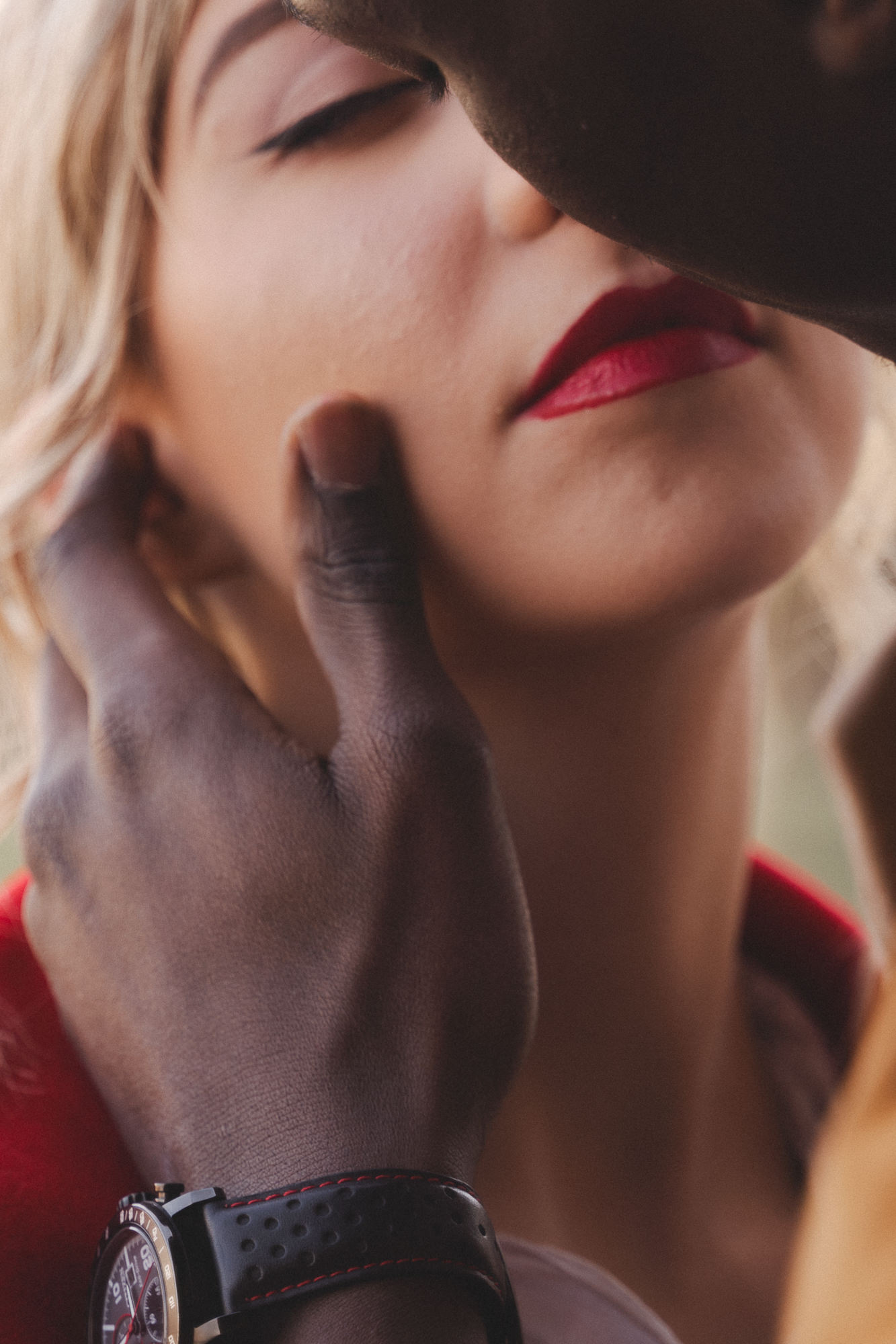 Macro detail shot of a hand touching a face during a romantic wedding session in Florence.
