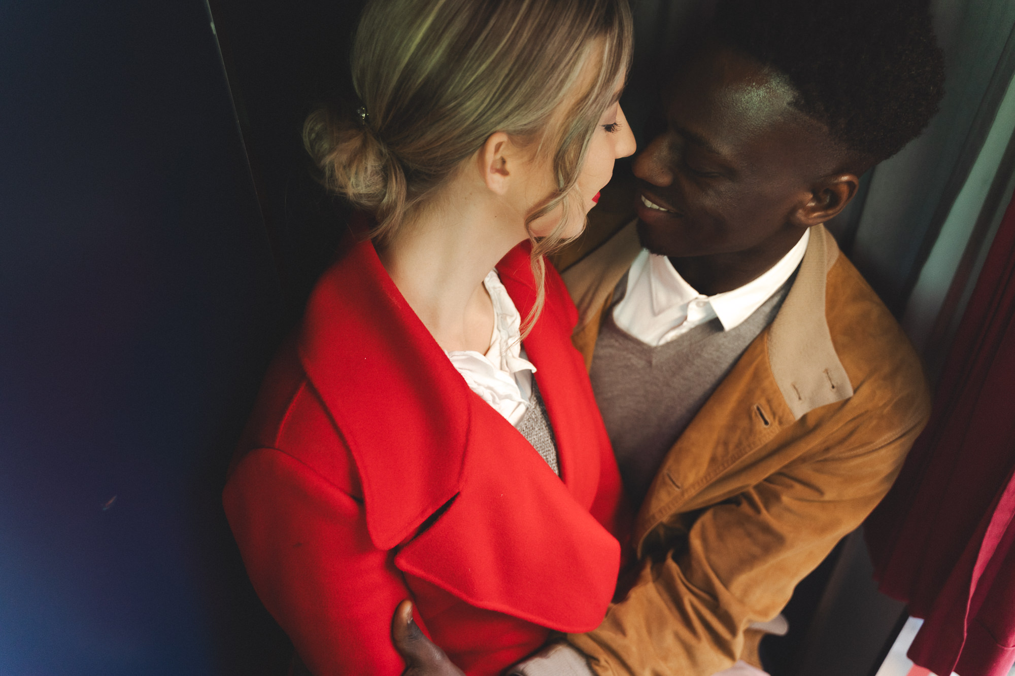 High-angle intimate shot of the couple inside the photo booth
